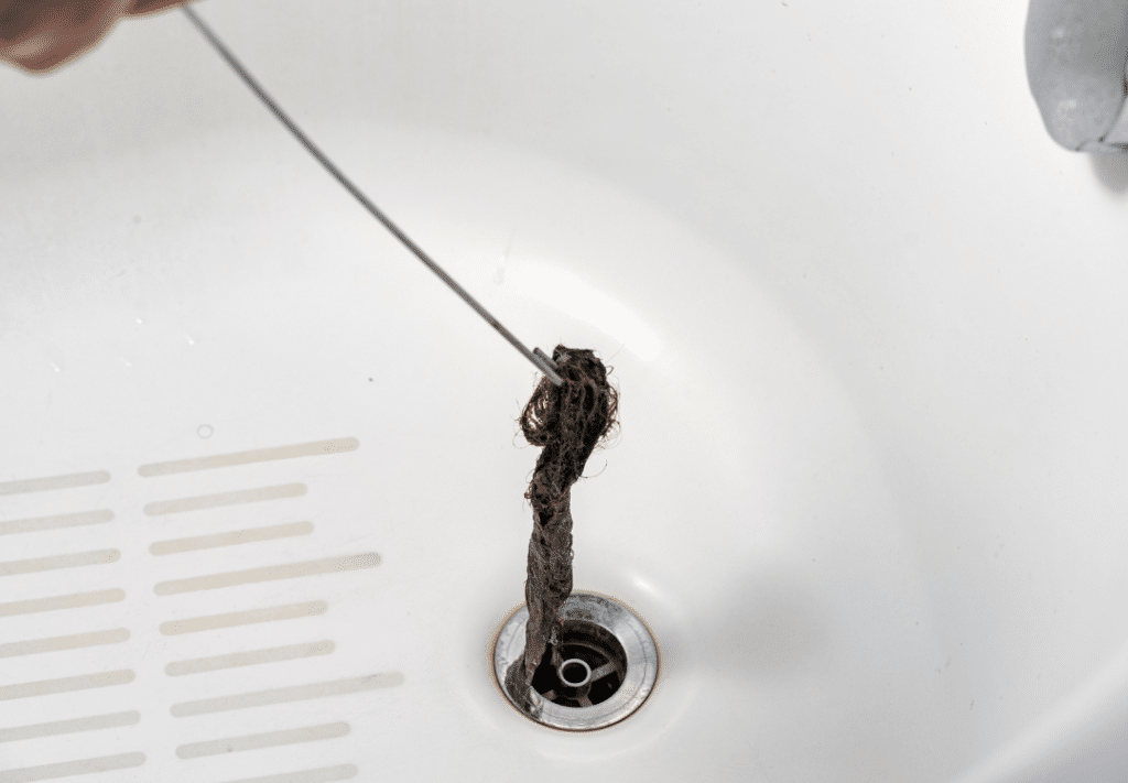 Wire hook pulling out hair from the bathtub drain