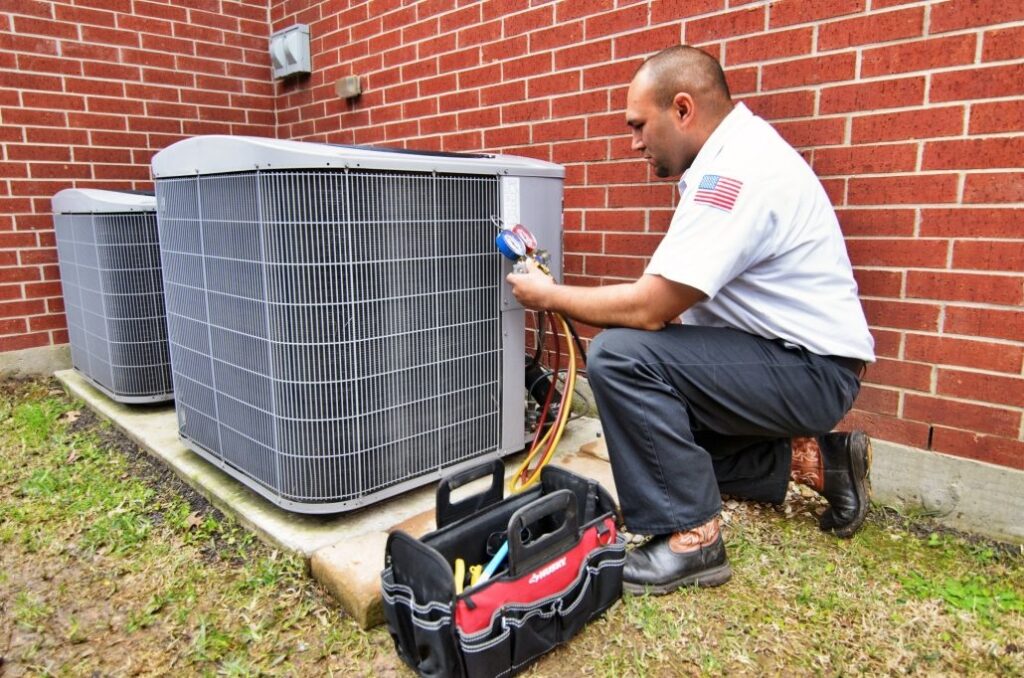 HVAC Contractor working on an AC unit