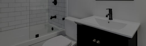 a white and black bathroom with a modern vanity, white toilet, shower with a glass wall and a tub, and black fixtures