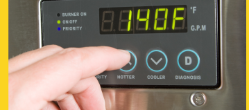 a close up of a temperature reading on a tankless water heater and someone presses the button to increase the temperature