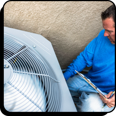 Technician performing maintenance on ac unit